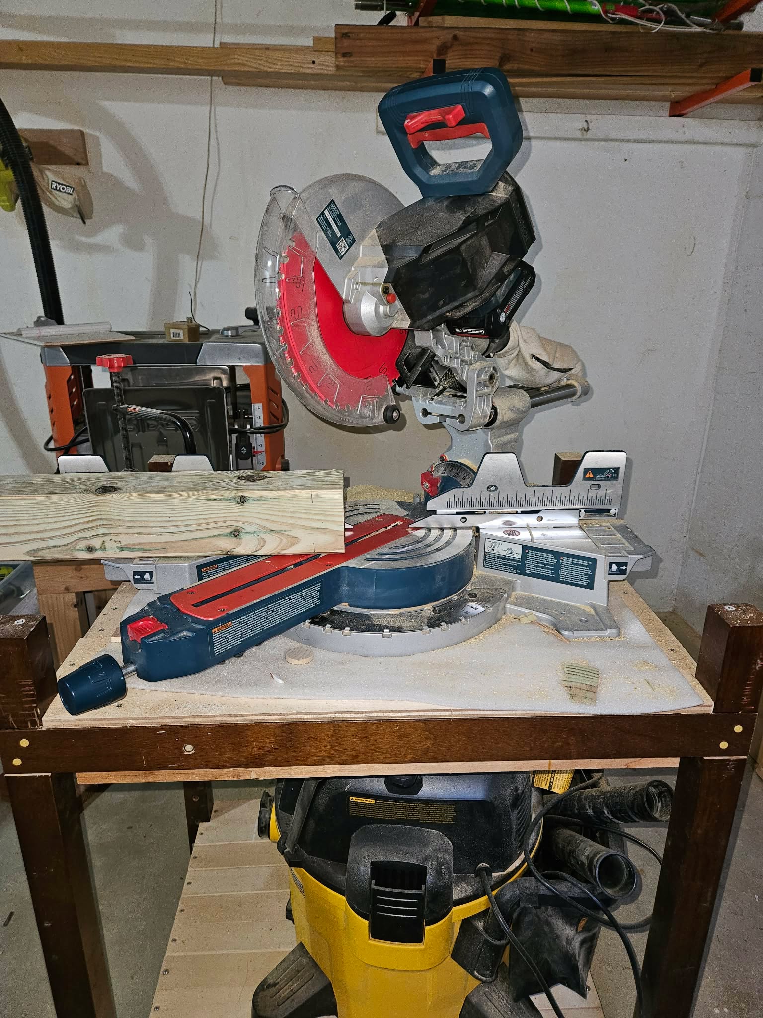 Cutting a board to length on the miter saw in the garage