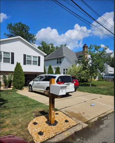 The completed mailbox post from the house — full front view