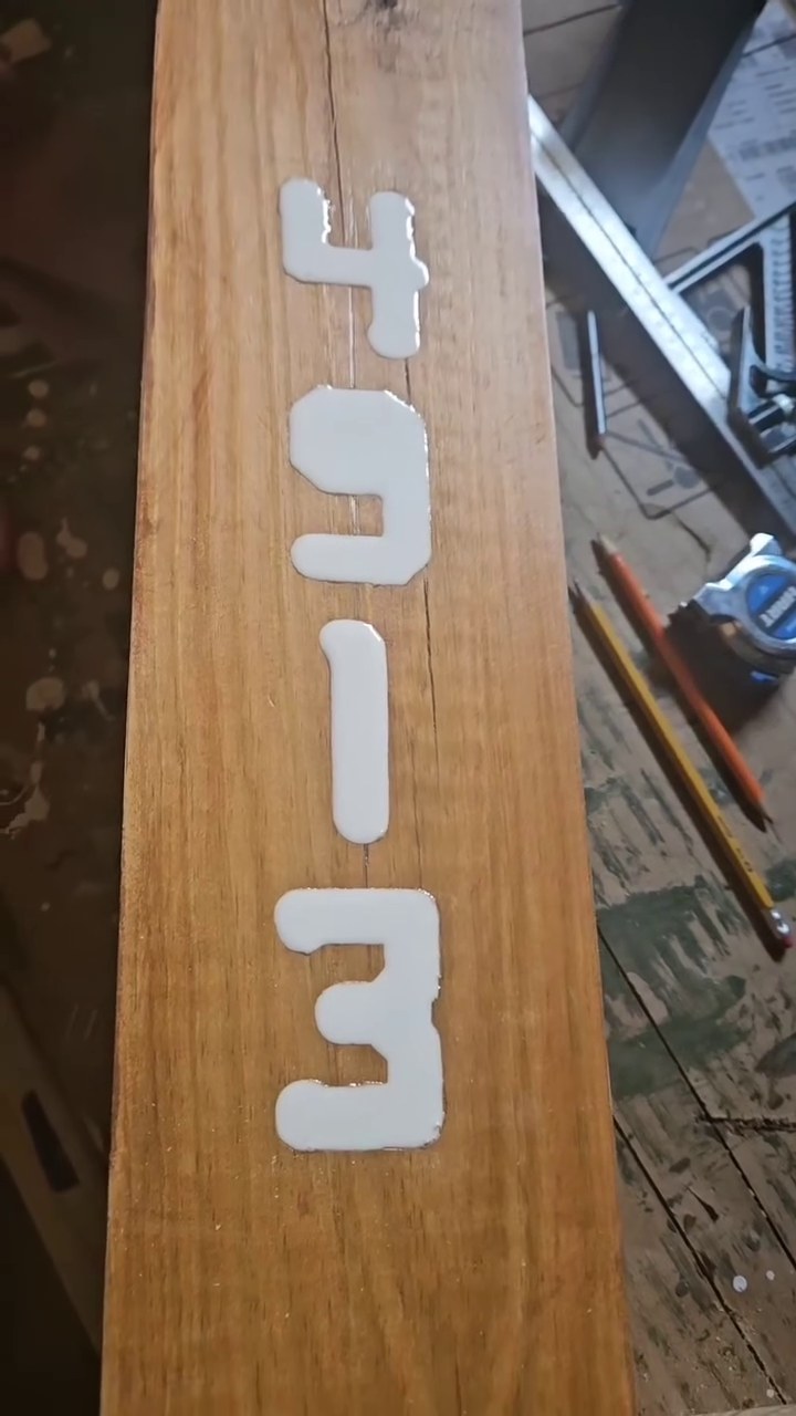 Close-up of the routed address numbers filled with white epoxy