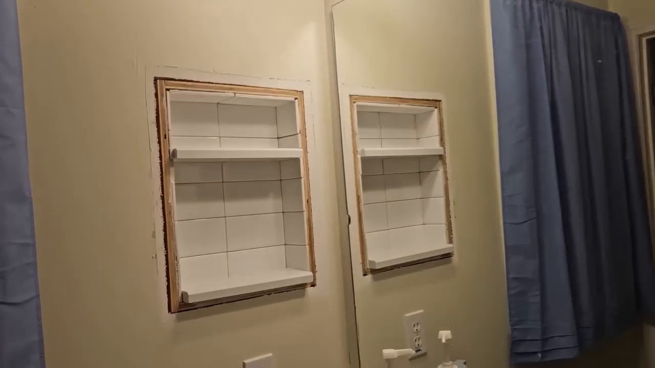 The tiled interior with two shelves, raw wood frame still exposed around the opening