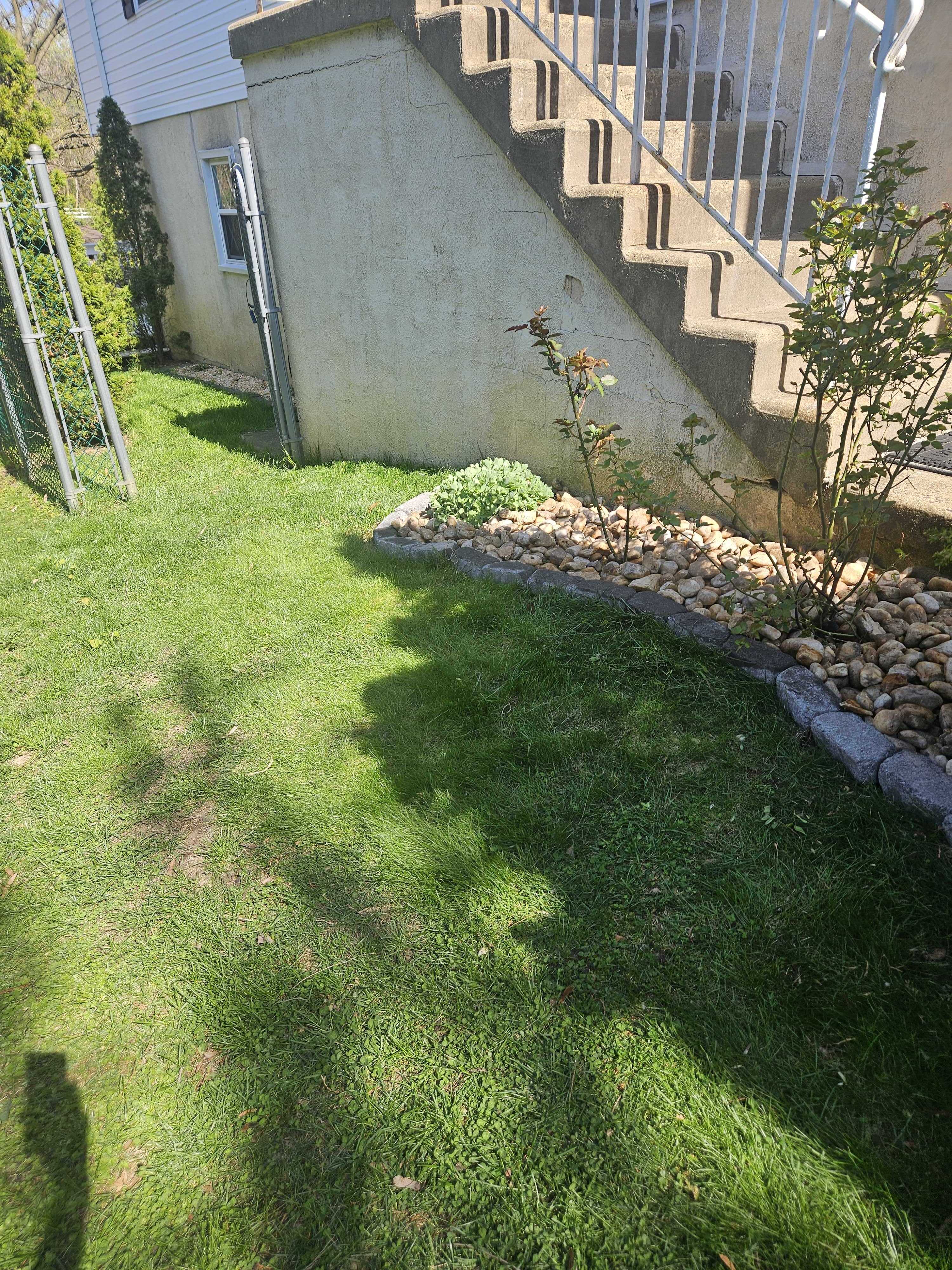Curved rock bed under the exterior staircase with block border