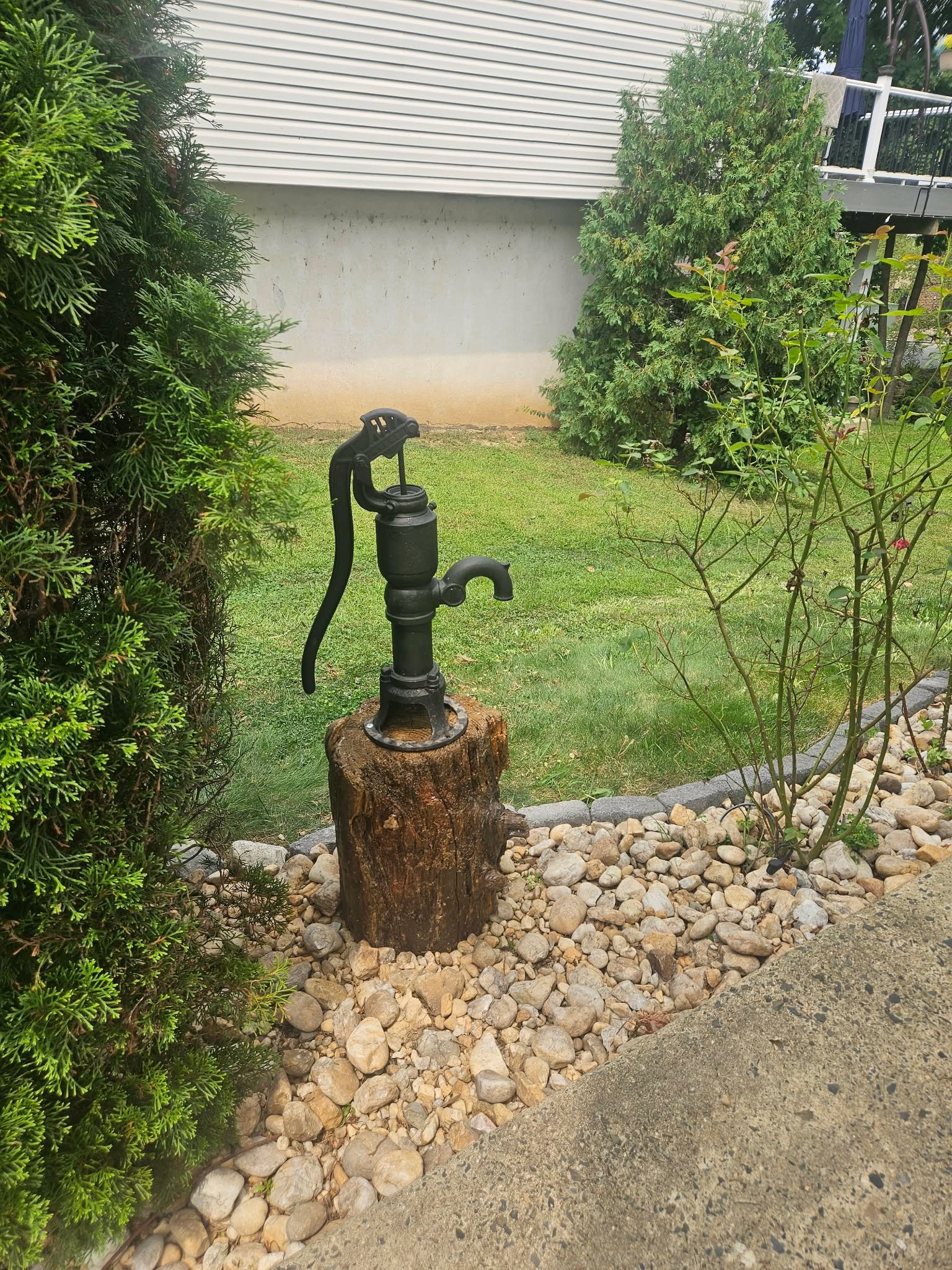 The completed well pump and stump display with the deck visible in the background